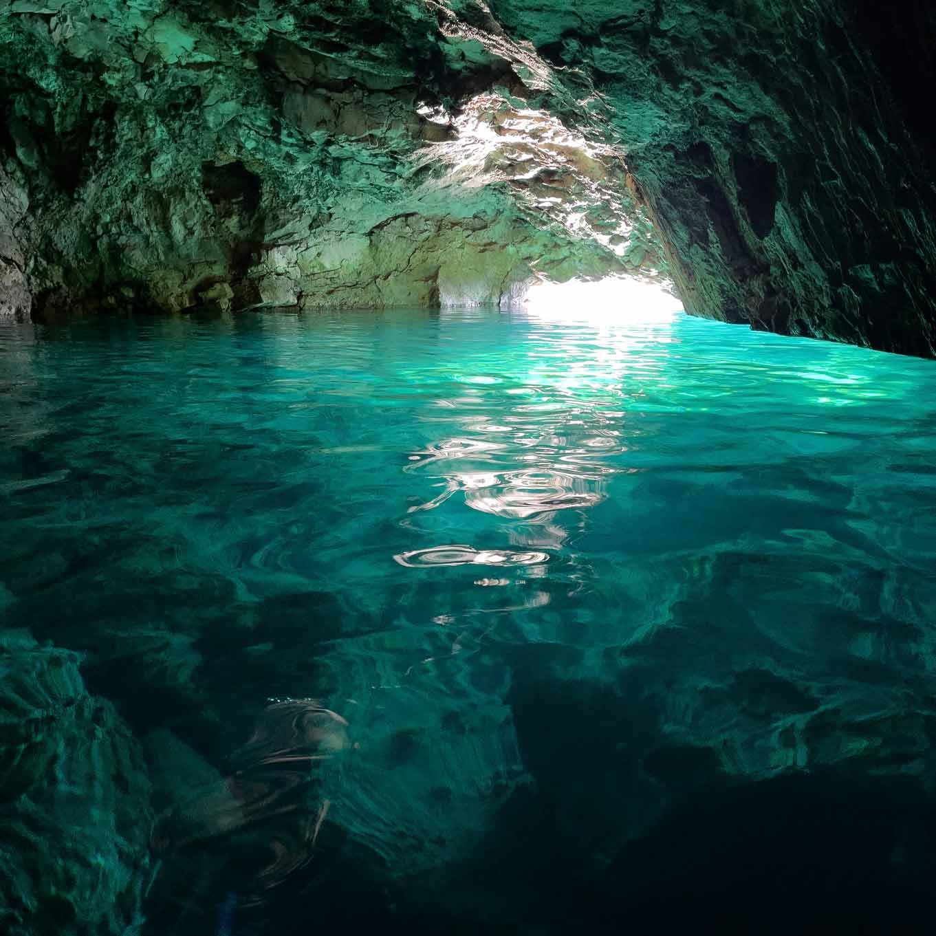 Light reflecting on turquoise water inside the Blue Cave at Morgiou.