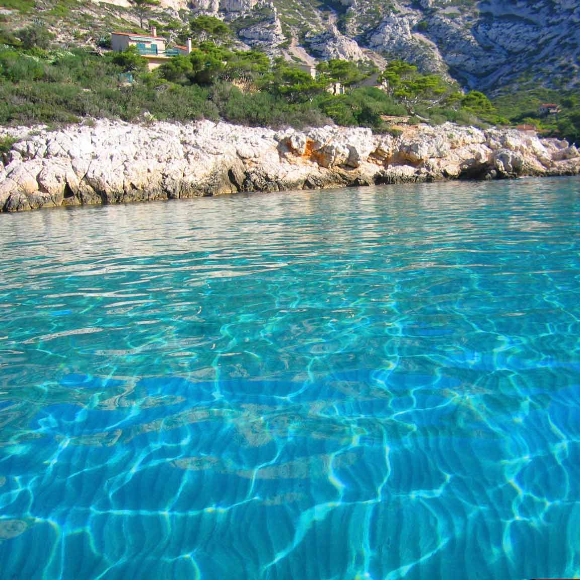 Shimmering crystal-clear waters at the foot of the Sormiou hills.