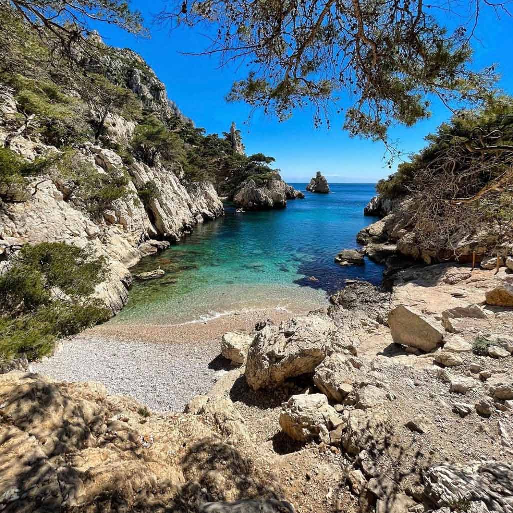 Secluded pebble beach and crystal-clear turquoise waters of Sugiton.