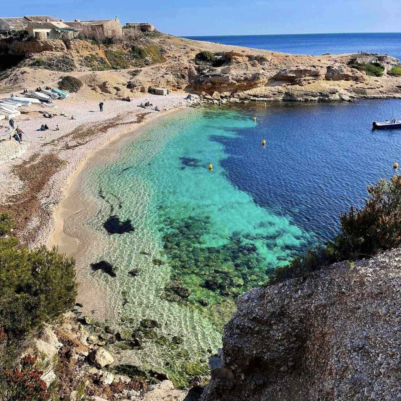 The pebble beach and translucent water of Marseilleveyre.