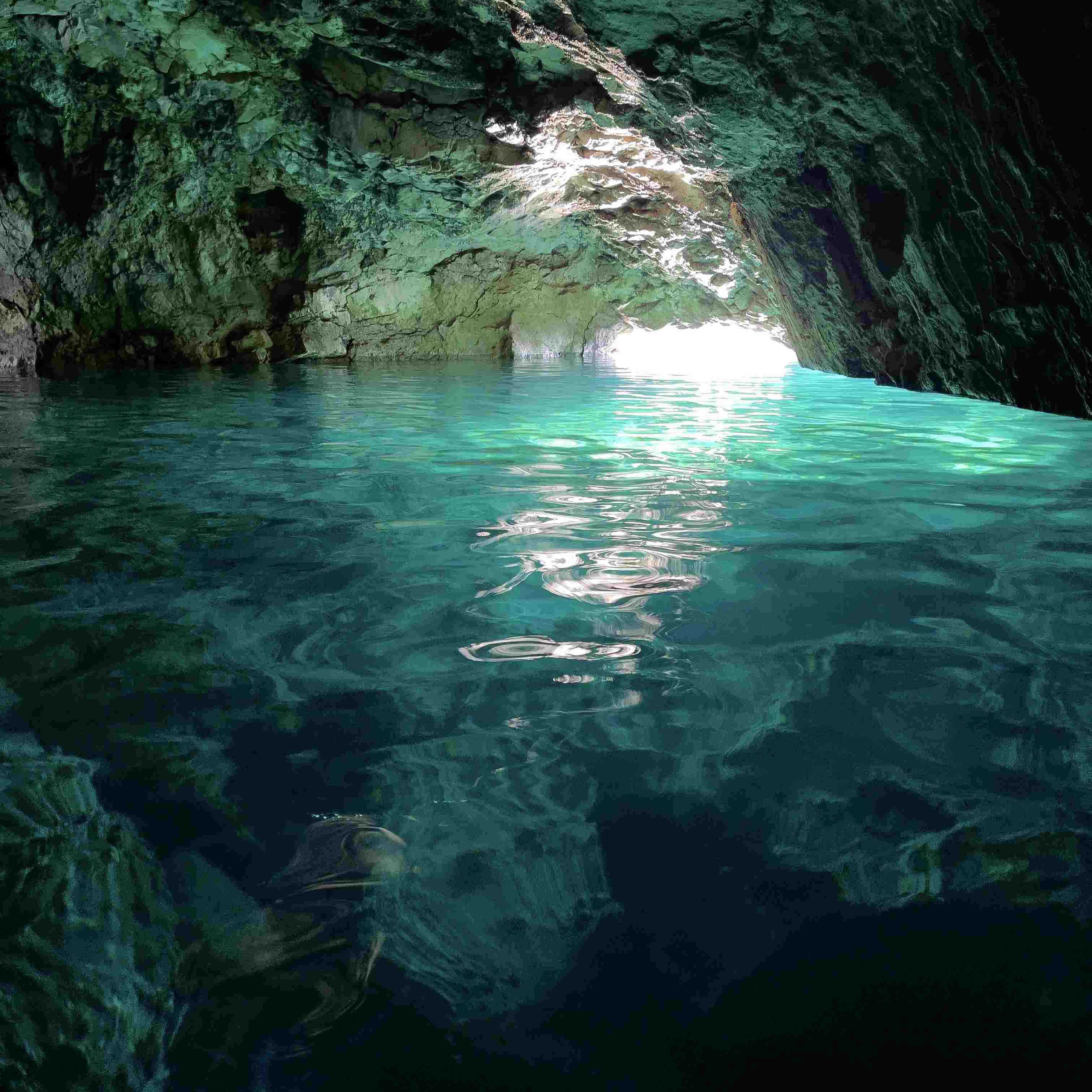 Glowing water inside the Blue Cave at Morgiou.